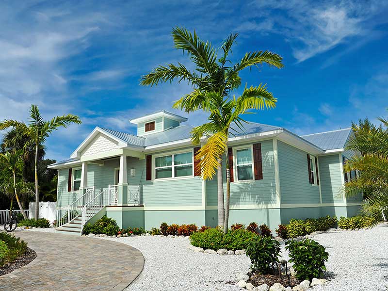 Coastal Florida home with palm trees, representing home and condo insurance coverage